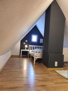 a attic room with a bed and a window at Schöne Wohnungen in Schwandorf in Schwandorf in Bayern