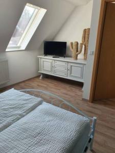 a bedroom with a bed and a tv in a attic at Schöne Wohnungen in Schwandorf in Schwandorf in Bayern +49 photos