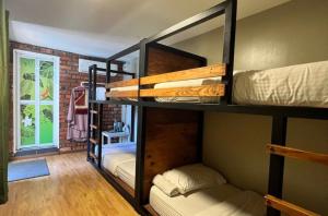a room with three bunk beds in a house at Petak Padin Cottage by The Pool, Kepala Batas Penang in Kepala Batas +64 photos