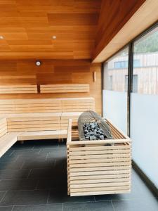 a sauna with a bench in a room with wood at All-Suite Resort Ötztal in Oetz