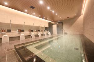 a swimming pool in a building with a swimming pool at Via Inn Prime Akasaka in Tokyo