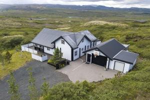 an aerial view of a house in a field at Blue Viking Luxury Cabin in Selfoss