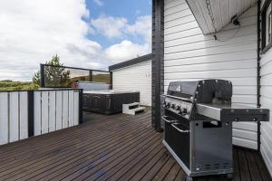 a grill on the deck of a house at Blue Viking Luxury Cabin in Selfoss