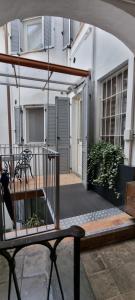 an outdoor patio with a table and a bench at Le Stanze di Rigoletto in Parma