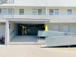 a building with a stairway leading to a building with a door at Chic City-View Apartments in Hanau in Hanau am Main