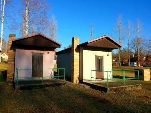 mały dom z gankiem na trawie w obiekcie Chatový tábor Malý Ratmírov w mieście Malý Ratmírov