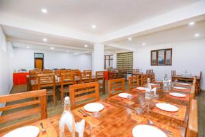 a large dining room with wooden tables and chairs at Sky Desert in Leh
