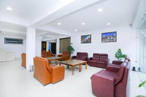 a living room with couches and a table and chairs at Sky Desert in Leh