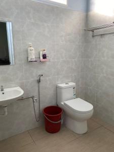 a bathroom with a toilet and a sink at HOMESTAY AYRIS, JURU, PENANG in Bukit Mertajam