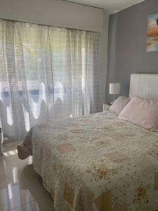 1 dormitorio con cama y ventana grande en Antibes, en Punta del Este