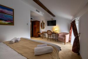 a bedroom with a bed and a living room at Carolina Heritage in Alba Iulia