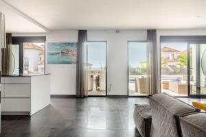 a living room with a couch and large windows at Villa in Finestrat in Finestrat