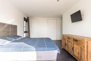 um quarto com uma cama e uma televisão na parede em Villa in Finestrat em Finestrat