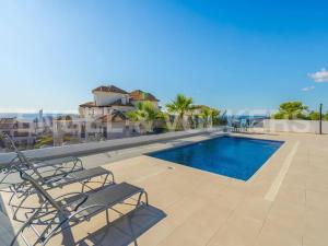 a swimming pool on the roof of a building at Villa in Finestrat in Finestrat