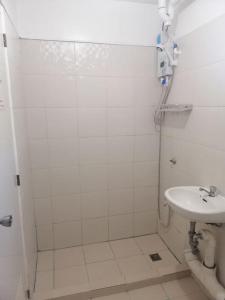 a bathroom with a shower and a sink at Raljer Homes in Manila