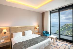 a hotel room with a bed and a large window at BLUE MUDANYA HOTEL in Bursa +36 photos