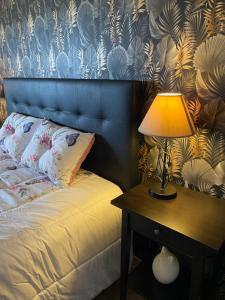 a bedroom with a bed with a lamp on a table at Casa da azinheira in Loulé +19 photos