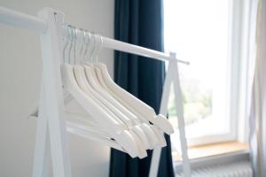 a white towel rack in a room with a window at Nautic Strandhotel in Sierksdorf