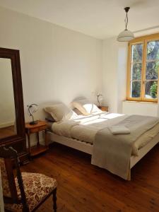 sypialnia z łóżkiem, krzesłem i oknem w obiekcie Château de Parançay - 15 people lodge w mieście Bernay
