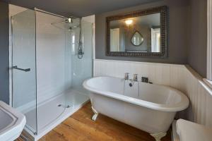 a bathroom with a tub and a shower and a sink at Host & Stay - Arncliffe View in Egton