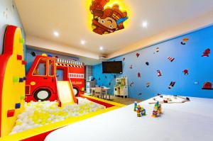 a childs bedroom with a toy truck and a bed at 童玩樂親子旅宿Toy Fun Hotel in Luodong