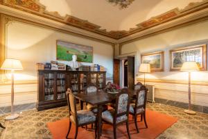 a dining room with a table and chairs at Villa Votanidi by VacaVilla in Borgo San Lorenzo