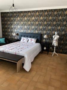 a bedroom with a large bed and a wall with a pattern at casa da ainheira 44 cruz da assumada 8100-296 Loulé in Loulé +26 photos