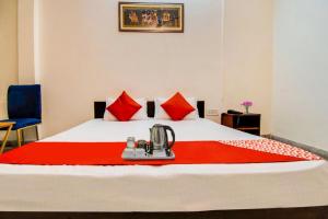 a hotel room with a bed with a red blanket at Royal Retreat By Hotel Aditya Inn in Jaipur