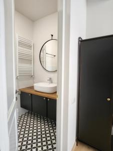 a bathroom with a sink and a mirror at Old Gold Anteon in Tbilisi City