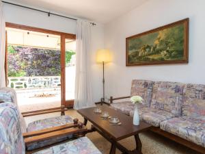a living room with two couches and a table at Apartment S'Esquirol Nº9 by Interhome in Begur