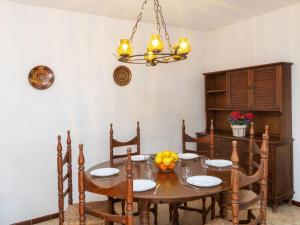 a dining room with a table and a chandelier at Apartment S'Esquirol Nº9 by Interhome in Begur +20 photos