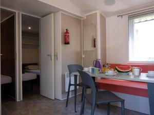 a kitchen with a table and chairs in a room at Holiday Home Residence Village-2 by Interhome in Cavallino-Treporti
