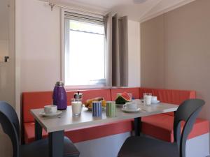 a table and chairs in a restaurant with a window at Holiday Home Residence Village-2 by Interhome in Cavallino-Treporti