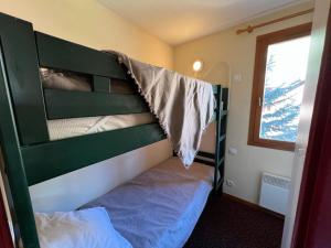 a bedroom with a bunk bed and a window at L'Alpaga by Mountain Collection Immobilier in La Salle-les-Alpes