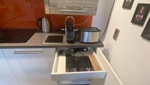 a kitchen counter with a sink and a phone on it at Stilvolle Wohnung in idyllischer Lage in Bad Säckingen +35 photos
