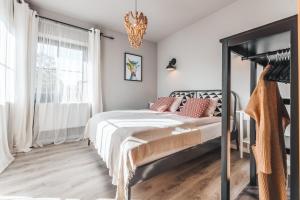 a bedroom with a bed and a chandelier at Bystry Comfort in Bukowina Tatrzańska