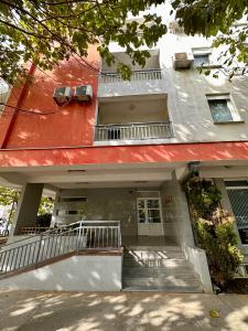 a building with a red roof and stairs in front at Apartman Filip in Podgorica