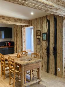 a dining room with a wooden table and chairs at La Porteille in Ax-les-Thermes +74 photos