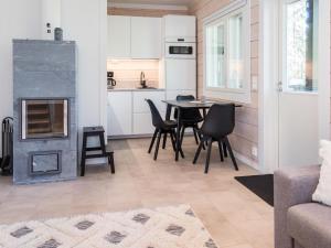 a kitchen and living room with a table and chairs at Holiday Home Kitkanvee 2 by Interhome in Kuusamo
