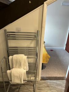 a towel rack in a room with a mirror at The Apple House in York