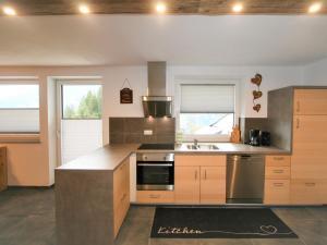 a kitchen with a sink and a stove top oven at Apartment Sonnigs Platzl by Interhome in Stumm