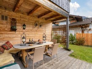 a wooden patio with a table and chairs on a deck at Apartment Orleans by Interhome in Hinterthal