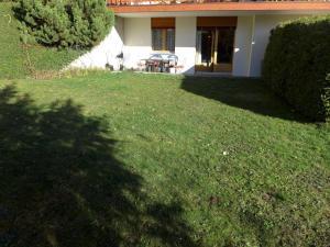 a yard of a house with a lawn sidx sidx sidx at Apartment Le Torrent by Interhome in Crans-Montana