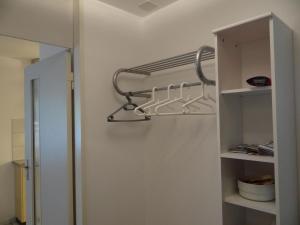 a closet with a towel rack on the wall at Apartment Sunnmatt Süd Wohnung 432 by Interhome in Engelberg