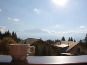 a coffee cup sitting on top of a table at Apartment Le Bouquetin 5 by Interhome in Villars-sur-Ollon