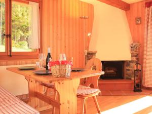 a room with a wooden table and a fireplace at Apartment Le Bouquetin 5 by Interhome in Villars-sur-Ollon