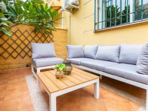 a couch and a coffee table on a patio at Holiday Home Villa Corales by Interhome in Torre de Benagalbón