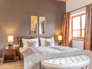 a bedroom with a large bed and a window at Holiday Home Katschberg 8 by Interhome in Rennweg
