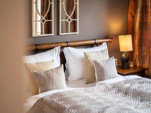 a bedroom with a bed with white sheets and pillows at Holiday Home Katschberg 8 by Interhome in Rennweg