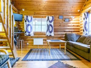 a living room with a couch and a table at Holiday Home Lumomarja by Interhome in Pyhätunturi
